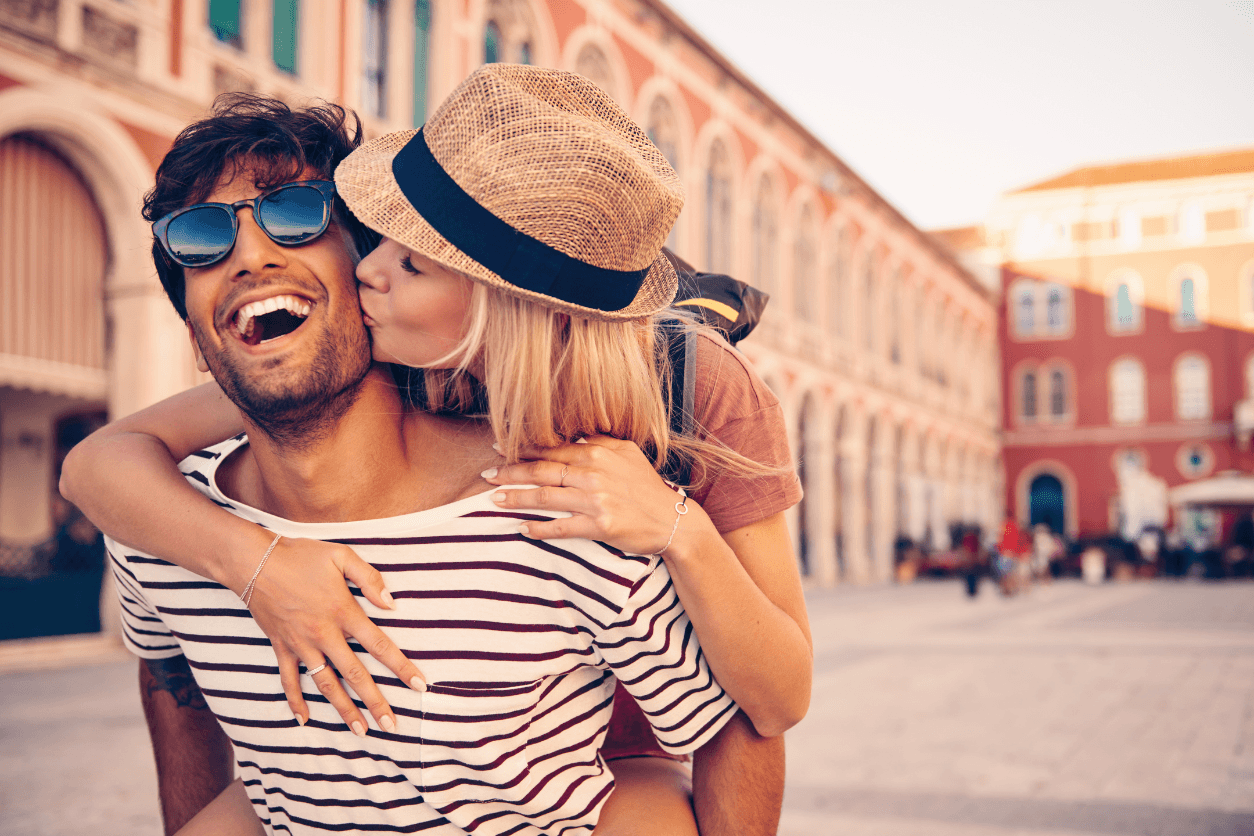 Smiling couple in a sunny city square