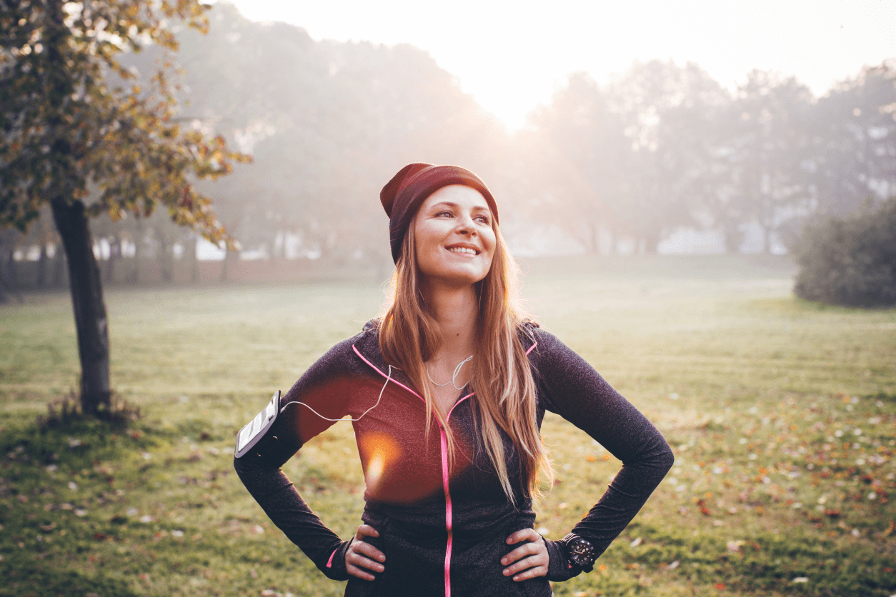 Woman in running gear in a sunlit park