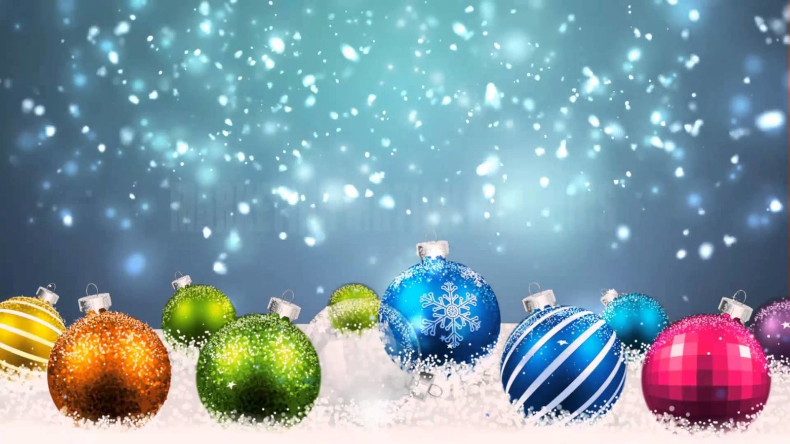 Colourful Christmas baubles on snow